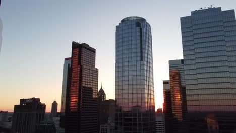 a stunning sunset over a modern urban skyline with reflections on glass towers, capturing the beauty of a city's architecture against the dimming sky