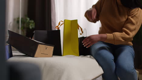 woman with shopping bags on a bed