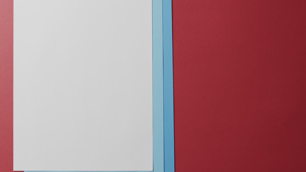 Close up of blank and blue cards on red background with copy space in slow motion