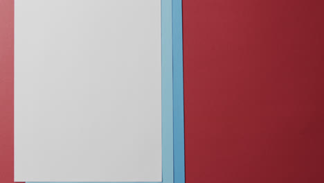 close up of blank and blue cards on red background with copy space in slow motion