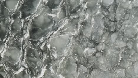 ice sheets form on water ascending aerial 4k