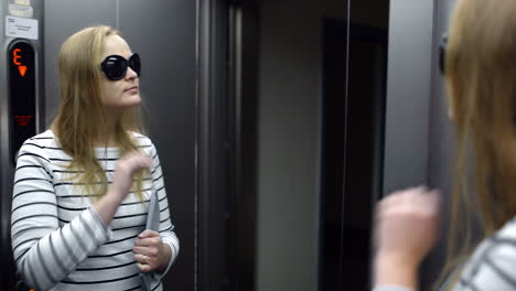 young woman in the lift primping and make funny face