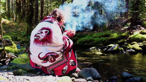 sangoma - shaman woman at the creeks edge with a burning bowl, speaking with her ancestors