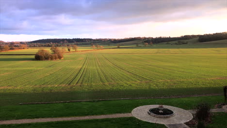 leicestershire manor house view over field and courtyard with green paddock and blue pink skies during day diagonal angle