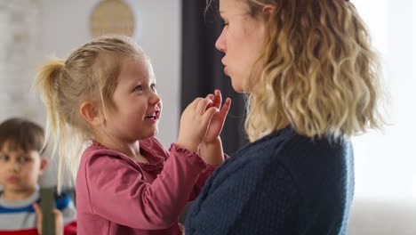 Close-up-video-of-mom-with-a-little-daughter-on-her-arms