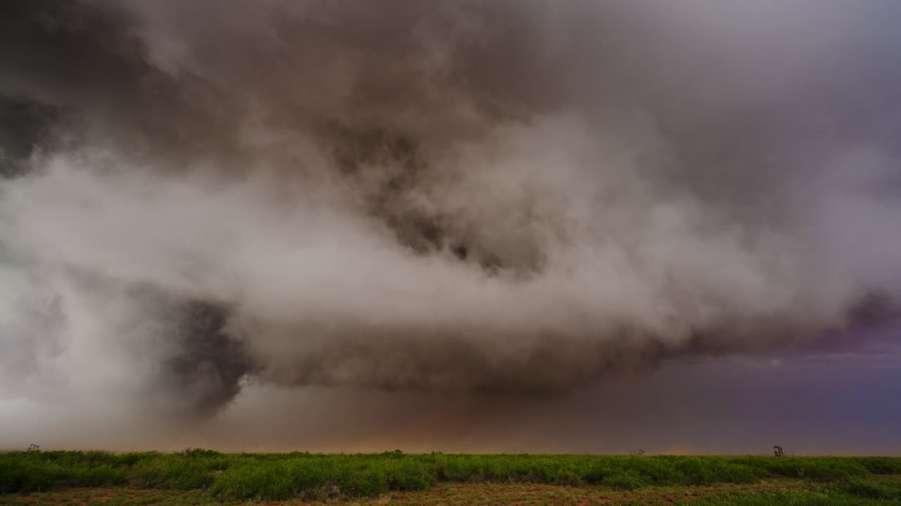 Dark Sky Filled with Motion as Powerful Storm Clouds Sweep Over Landscape