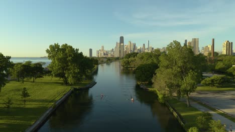 aerial, people rowing in lincoln park with chicago skyline in background