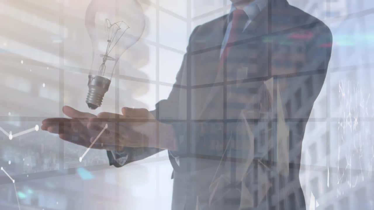 Animation of light bulb over businessman's hands in office background