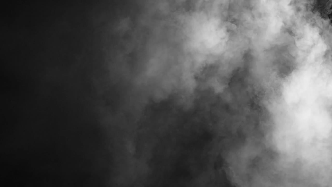 Realistic white smoke or fog slowly billows from right side on black background. Use as overlay for atmospheric, moody, or mysterious scenes