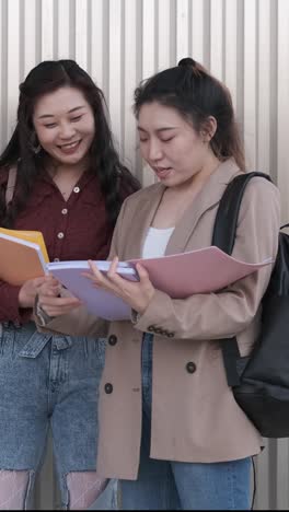 portrait of a group of asian woman college students talking together outdoors on the street.