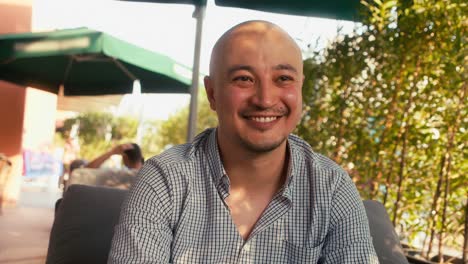 portrait of handsome asian smiling man in the cafe