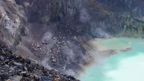 steam rises off opaque green lake in crater of santa ana volcano, slv