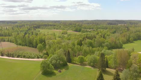 serene aerial view on sunny day of kurzeme nature park, flying forward