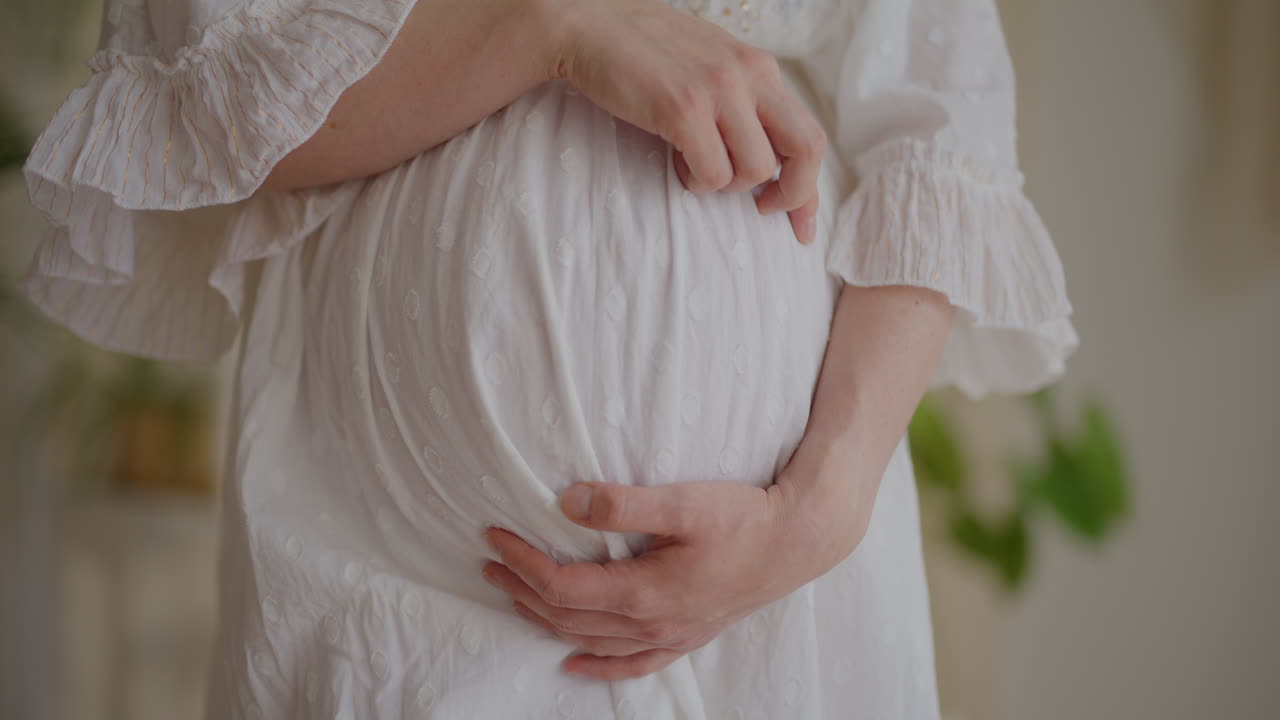 Pregnant Woman Touching Belly in Expectation