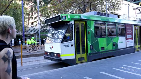 tram, cyclist, and pedestrians in melbourne city traffic