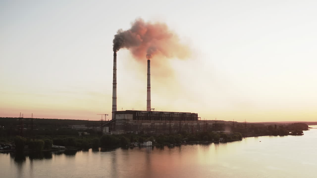 Industrial zone with large chimney. Aerial view of high smoke stack with smoke emission