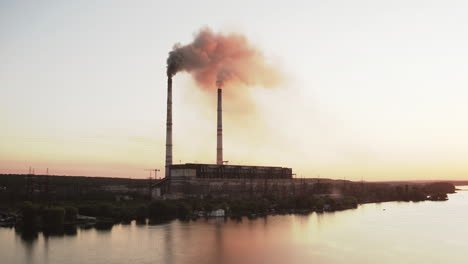 industrial zone with large chimney. aerial view of high smoke stack with smoke emission