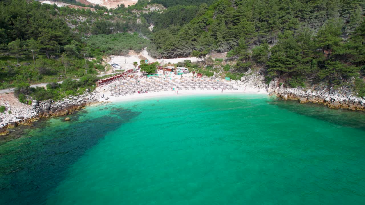 Unveiling the Whirling Aerial Spectacle of Marble Beach, Where Pristine White Sands Meet Emerald Waters and Verdant Greenery, on the Idyllic Thassos Island, Greece