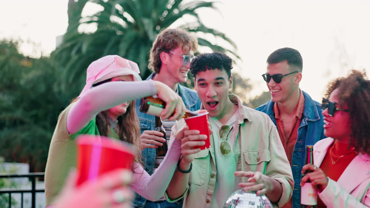 Group of friends celebrating and drinking beer at a party