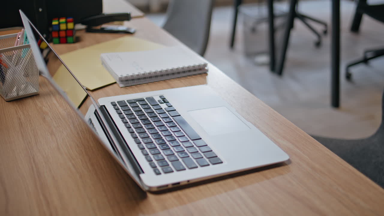 Modern laptop standing desk at office closeup. Computer placed wooden table