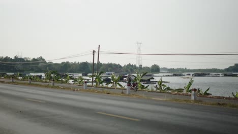 roadside view of floating houses and a river