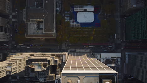 Aerial-birds-eye-overhead-top-down-view-of-streets-in-city.-Outdoor-ice-rink-in-Bryant-Park-in-midtown.-Manhattan,-New-York-City,-USA