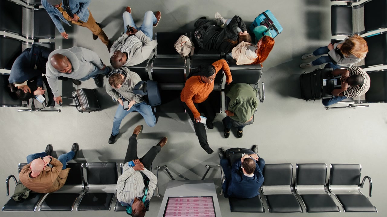 Top down view of passengers in airport napping after cancelled flights