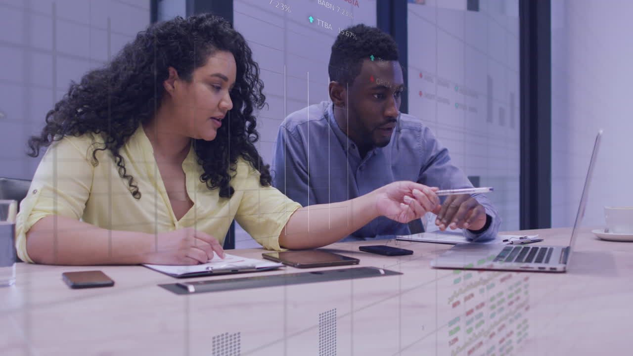 Animation of statistical data processing over diverse man and woman discussing over laptop at office