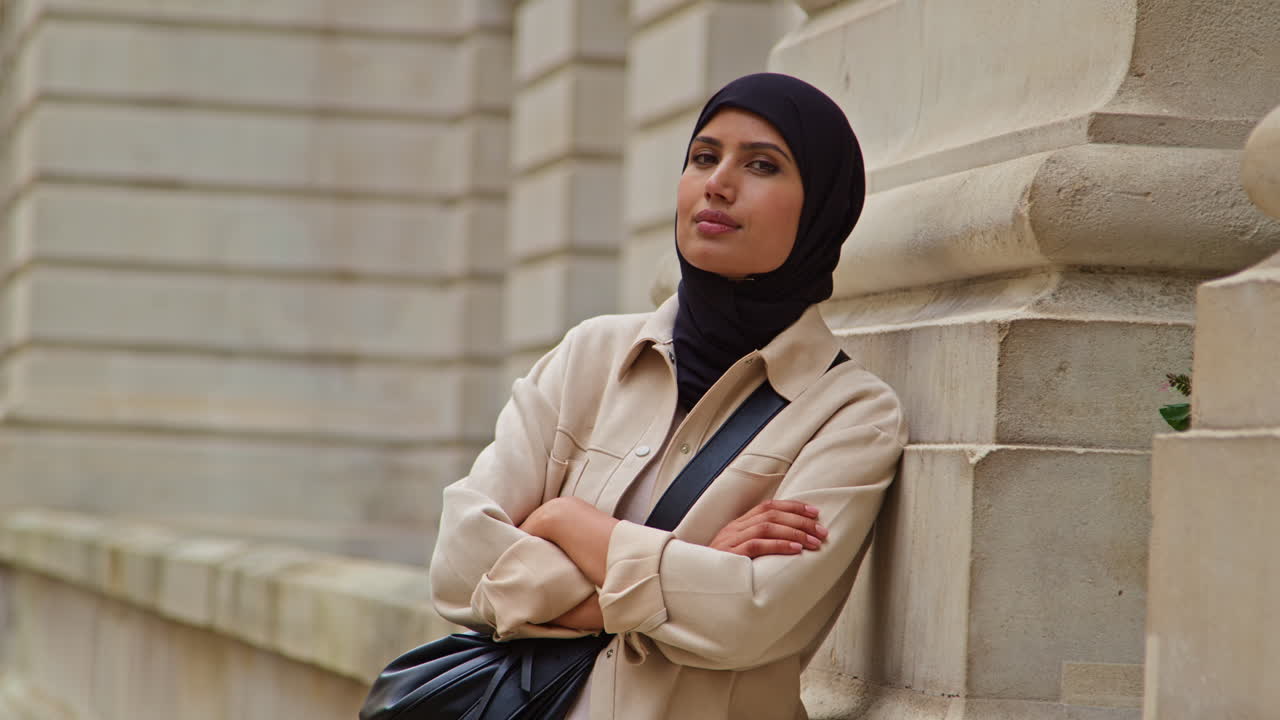 Muslim Businesswoman Wearing Hijab And Modern Business Suit Standing Outside City Office Buildings 2