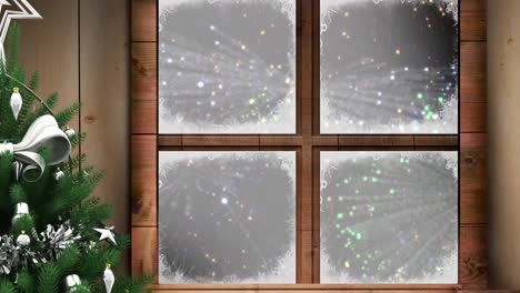 christmas tree and wooden window frame against colorful fireworks exploding on black background