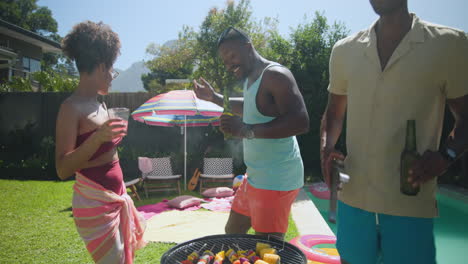 diverse friends enjoying sunny day by pool, setting up for outdoor fun