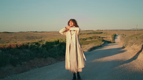 Walking-girl-enjoying-evening-sunlight-vertically.-Single-serene-woman-stretch