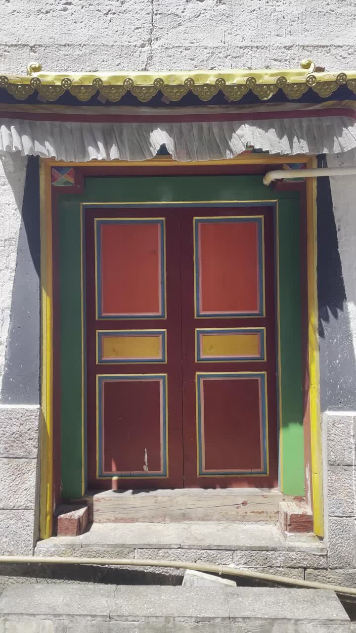 Vertical view of Temple entrance, colorful door at Shangri la, Chinese Tibetan architecture