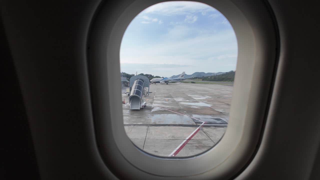 Koh Samui airport airplane window view of tarmac Thailand Southeast Asia air travel holiday