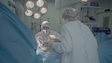 medical staff of the operating unit do heart surgery nurse assists in performing the operation suturing a wound