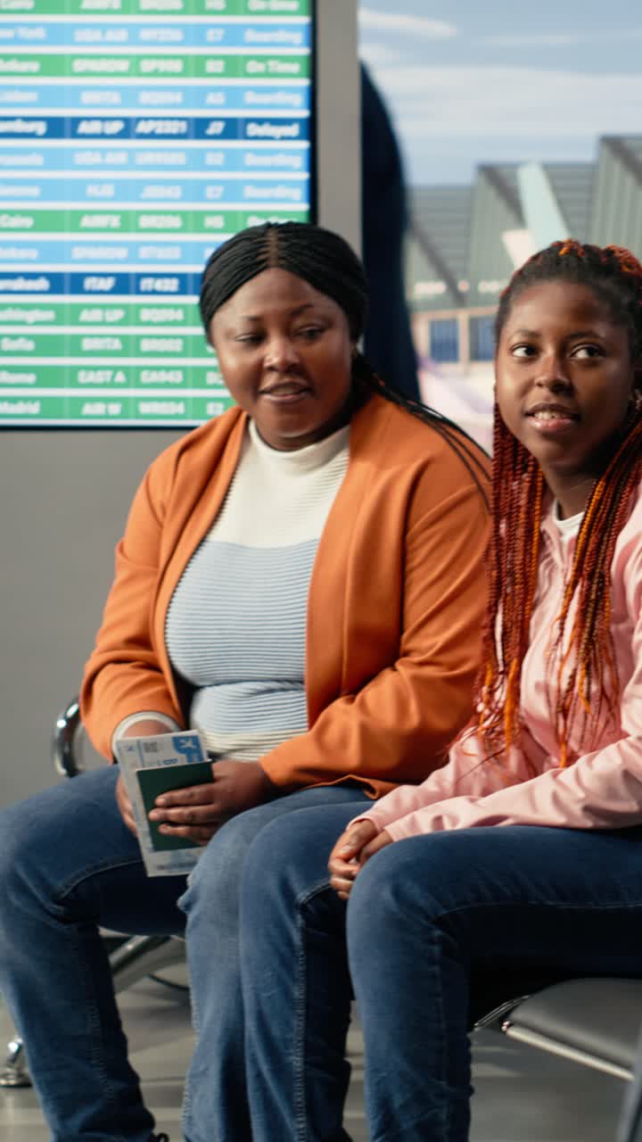 Happy African American Women Talking in Airport Departure Lounge
