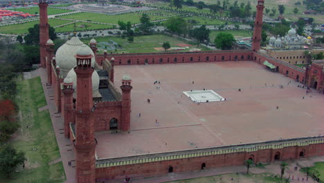 lahore, pakistan, badshahi mosque aerial view with minar-e-pakistan, park of the minar-e-pakistan, another side is a gurdwara of sikhs, visitors ladies, gents and children are in the mosque