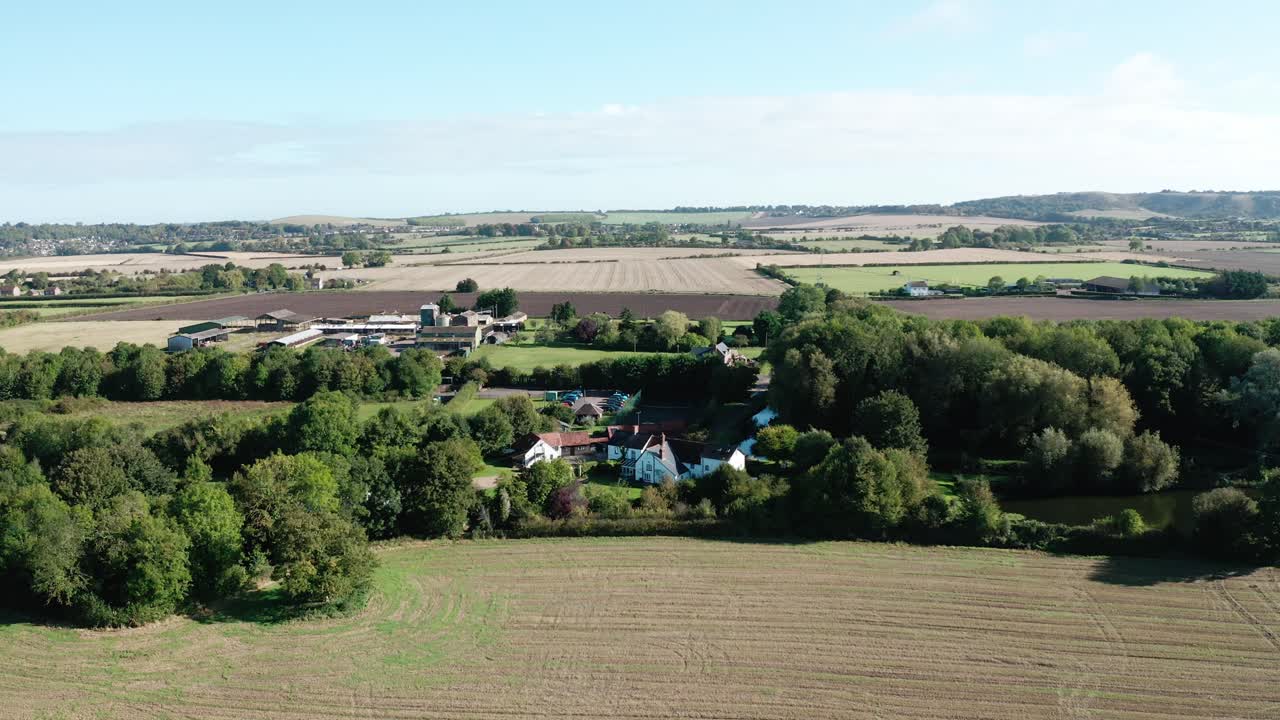 Drone footage of rural Dunstable with organized fields and meandering natural barriers