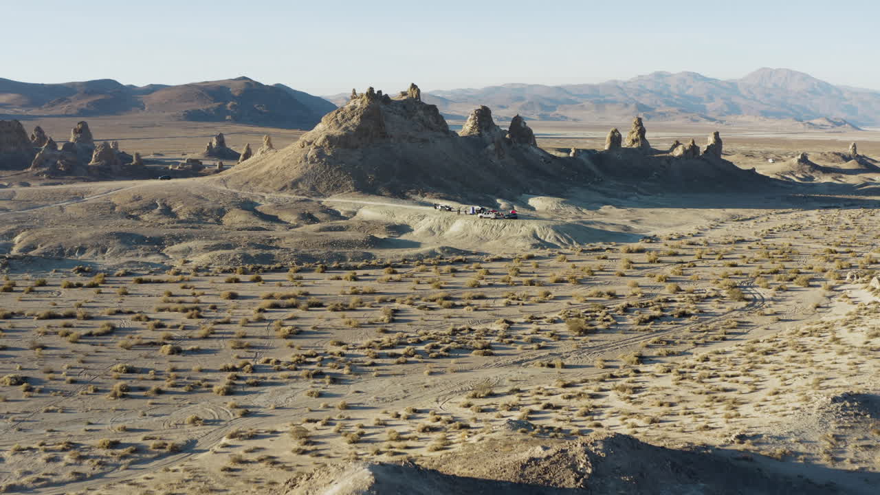 Smooth panning shot of a campsite in front of the trona pinnacles at daylight