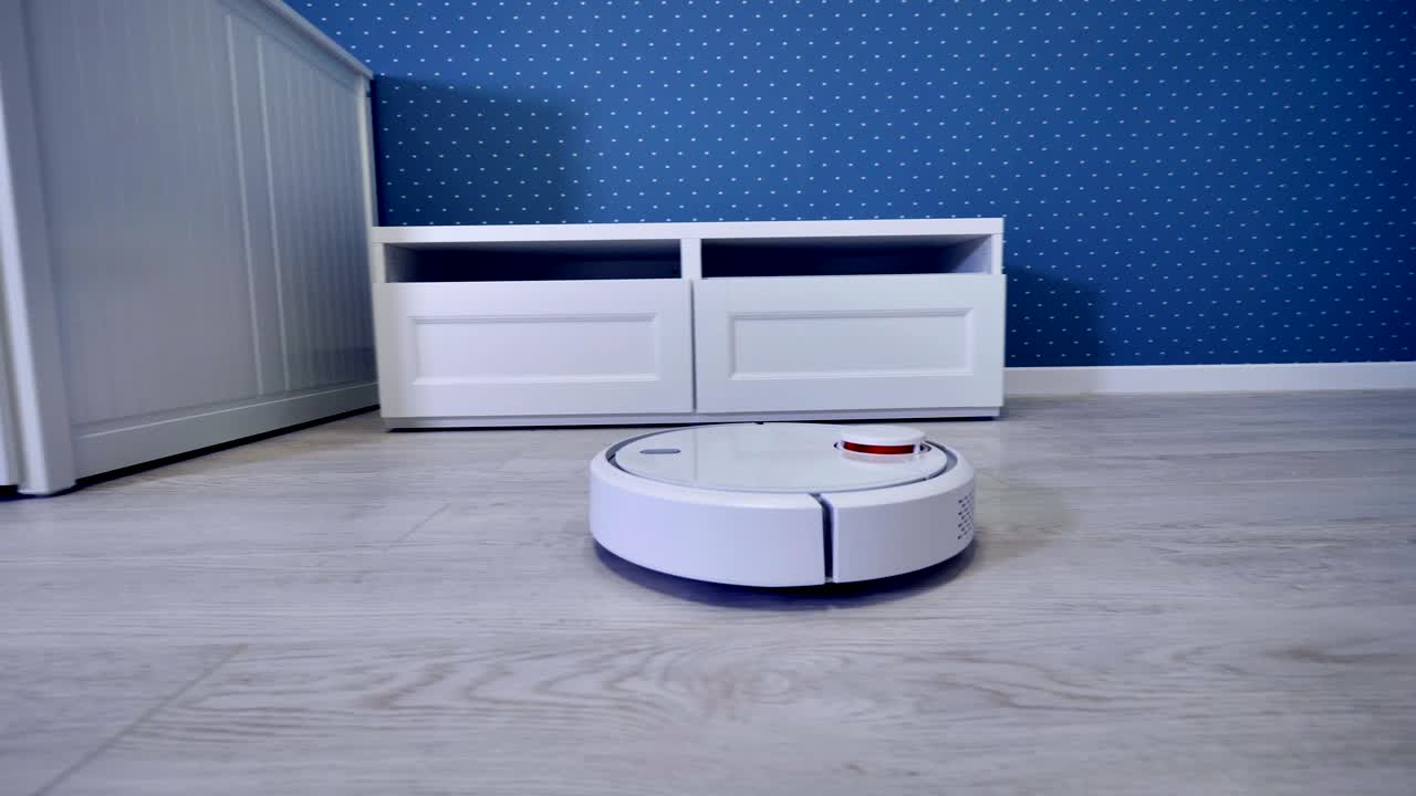 A robotic vacuum cleaner starts its routine from the door.