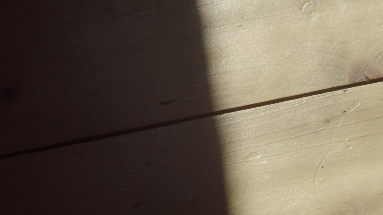 Cinematic close-up of a wooden plank revealing grain and warm tones. Excellent for design mockups, craftsmanship, and texture studies