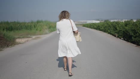 woman walking down a country road
