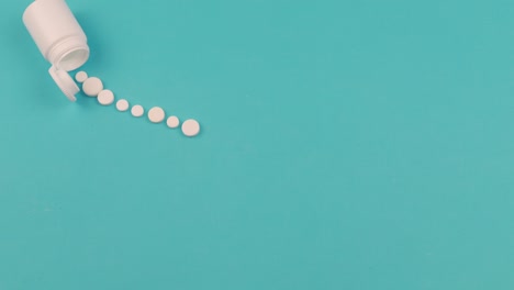 4k stop motion animation of white pill on blue background