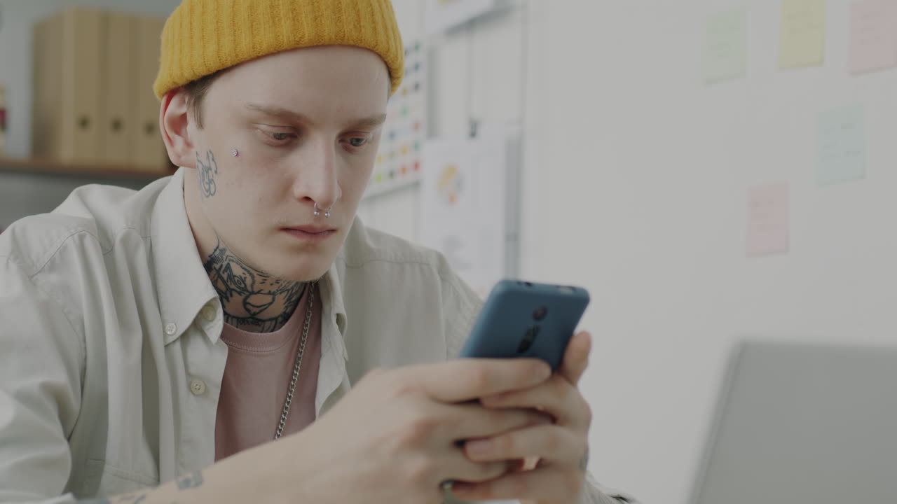 Young Person Using Mobile Phone in Office Setting
