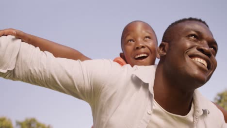 man carrying his son on his back