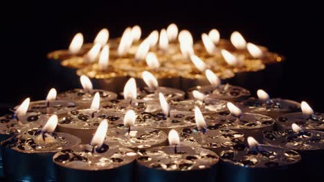 Background-of-tea-cup-glitter-Candles-Lights-shines-yellow-gold-bright-for-celebration,-religion,-anniversary-Festival