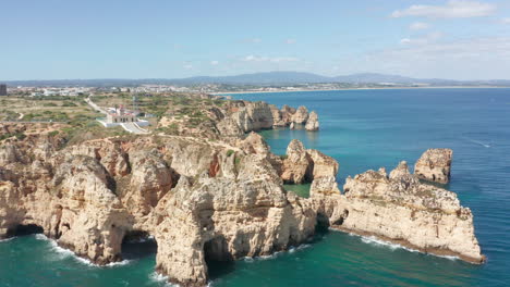 Cinematic-aerial-over-beautiful-eroded-cliffs-on-the-shores-of-a-blue-sea