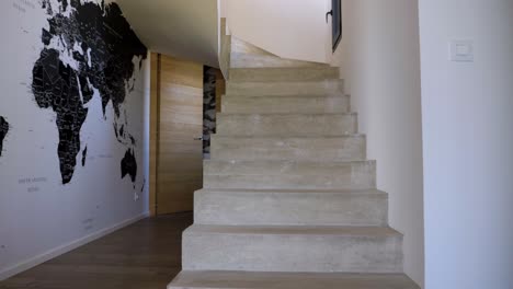 slow tilting shot revealing a stone villa staircase with vertical wooden paneling