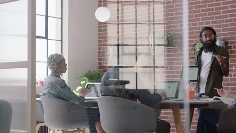 young-indian-businessman-using-digital-tablet-computer-presenting-financial-graph-data-showing-colleagues-in-office-presentation-diverse-team-collaborating-brainstorming-strategy