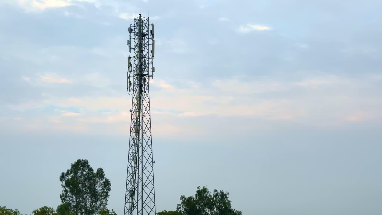 tilt up shot of a mobile network communication tower in india
